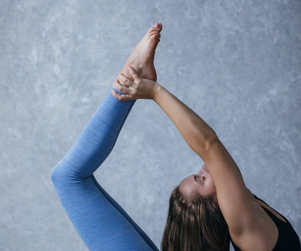 Person holding a challenging yoga balance pose showing strength.